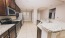 a kitchen with a marble counter top