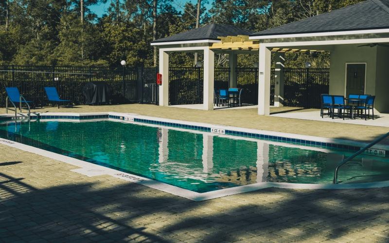 a swimming pool with a covered patio