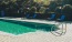 a swimming pool with chairs around it