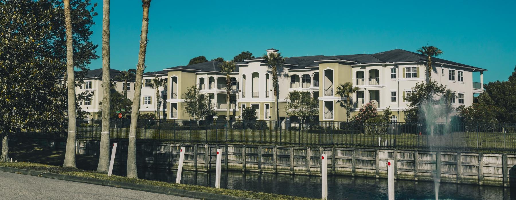 a white building with palm trees