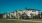 a large white building with trees in front of it