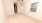 a room with a ceiling fan and carpet